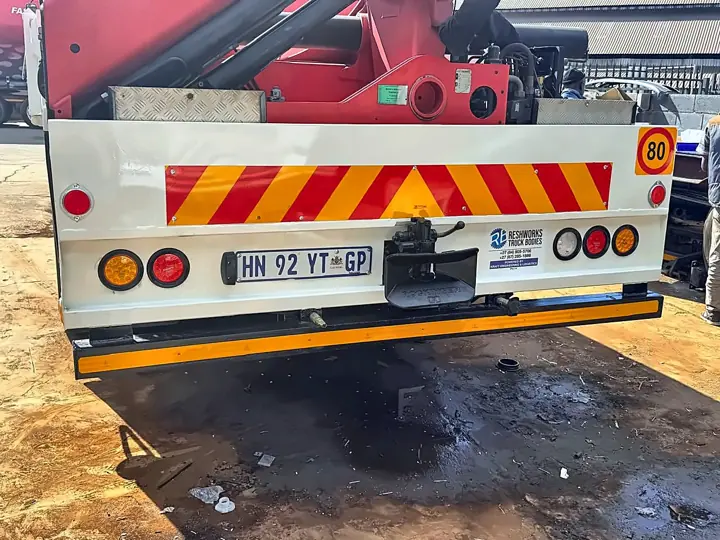 Crane truck rear bumper with towing hitch